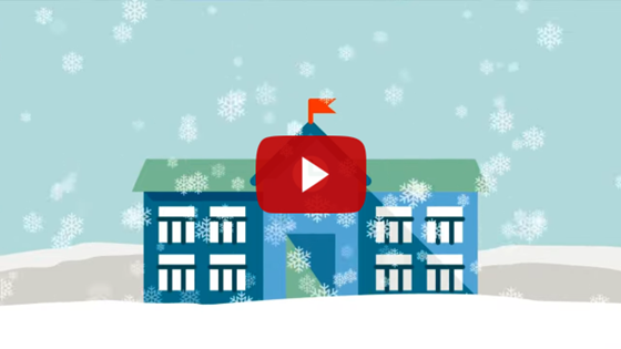 school building with snow falling and on ground