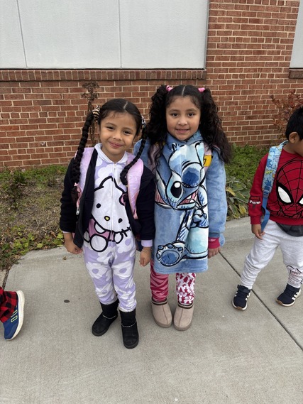 Two girls stand outside in their Pajamas for Pajama Day 