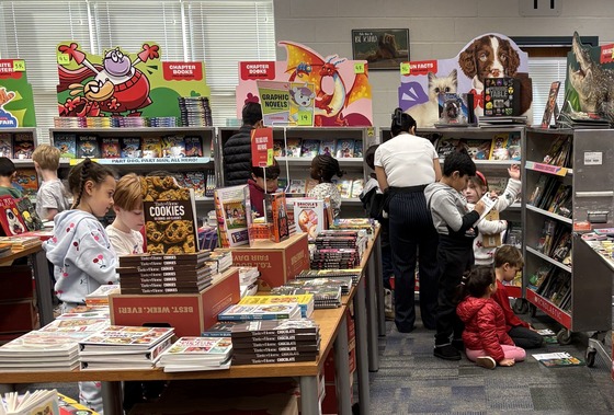 Children browsing through books and making wish lists