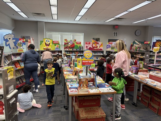 Children browsing through books and making wish lists