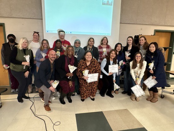 group of employees pose for picture after awards