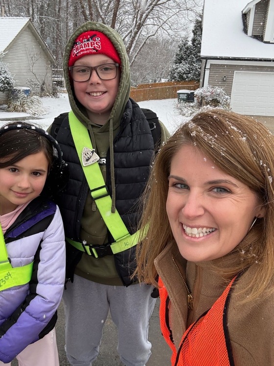 assistant principal with students in the snow