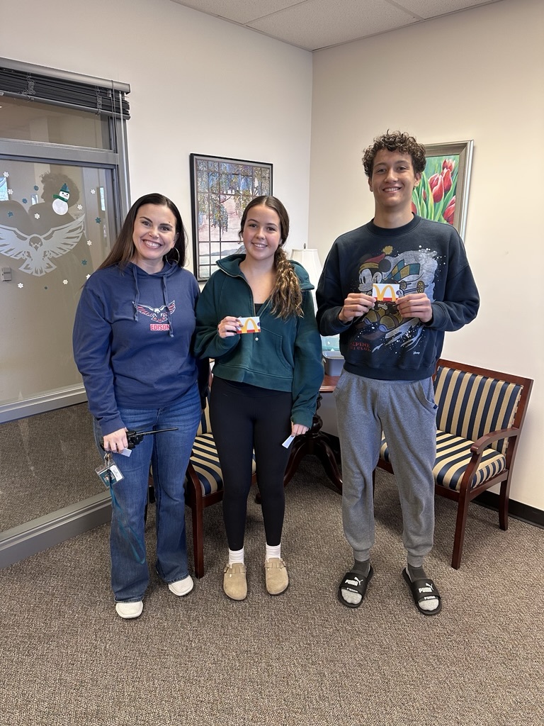 students standing in the office with gift cards