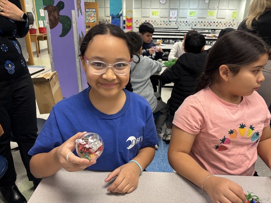 A girl poses with her ornament 