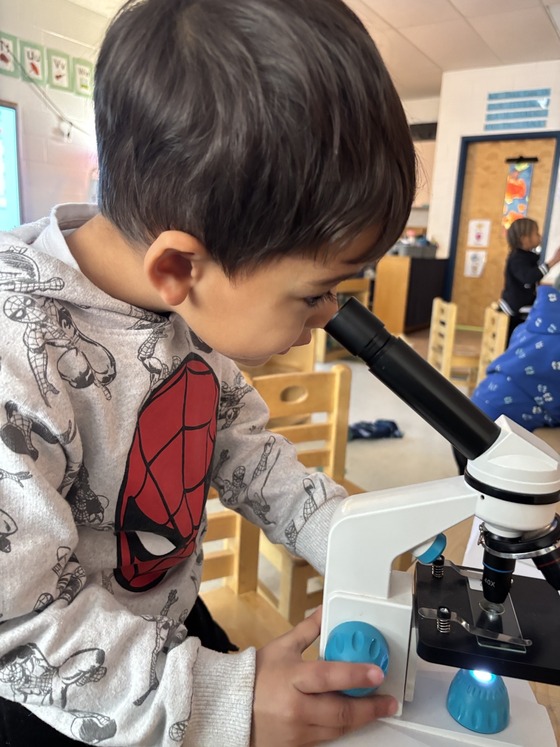 A child looks into a microscope