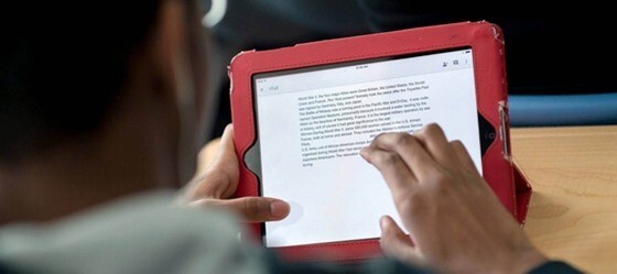 A photo of a person holding a tablet