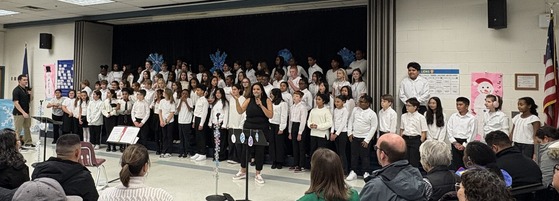 Music teachers Ms. McCormick and Mr. Crouch introduce the Lane Chorus before their Winter concert begins