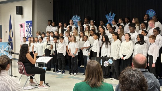 The Lane 5th and 6th grade Chorus performing on the stage in the cafeteria