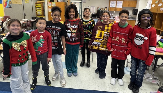 a group of students wearing many different holiday sweaters