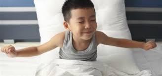 photo of boy stretching and waking up