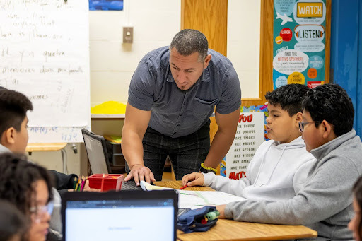 Teacher helps student with an assignment