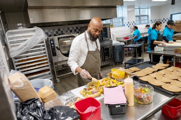 photo of food service worker preparing sandwiches
