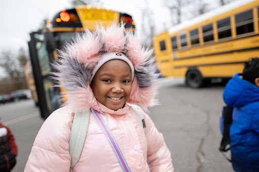student smiling in her winter jacket