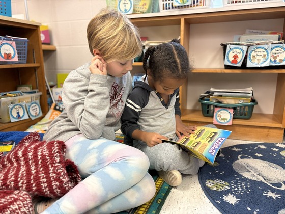 students reading a book together