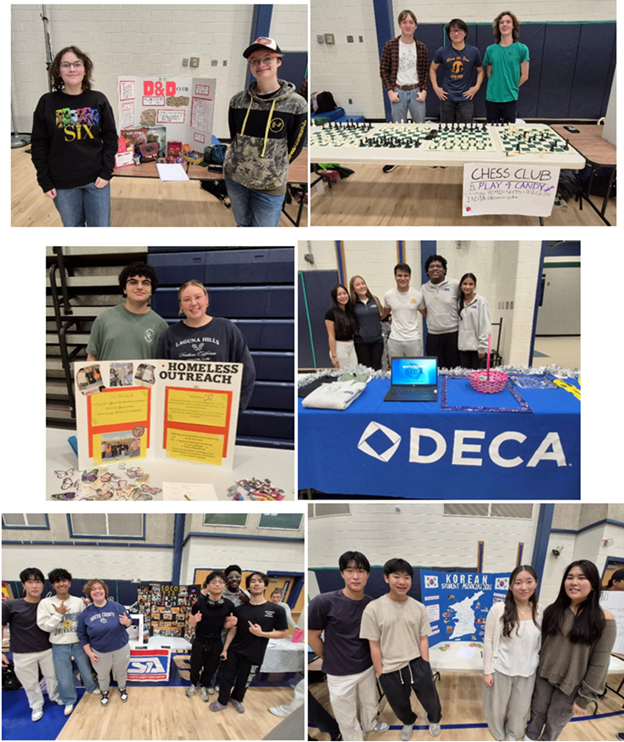 Students standing behind display tables