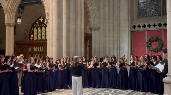 Students singing at a cathedral