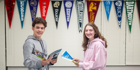 students looking at college materials together