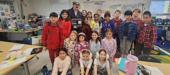 classroom full of students smiling for a photo
