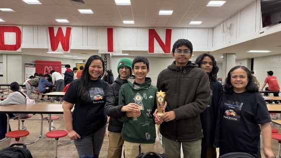 students smile with their trophy