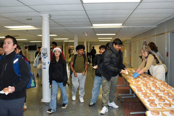Students getting their Krispy Kreme donut from staff on last day before Winter Break