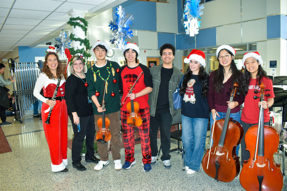 TJ Orchestra students posing with Dr. Bonitatibus