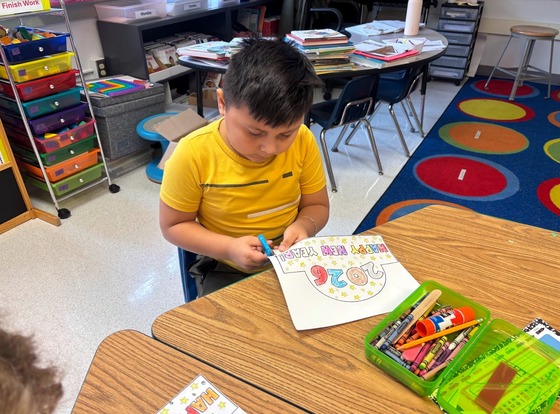 Student cuts out a piece of paper