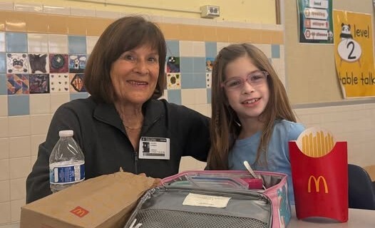 A student enjoying lunch with grandma as part of our Lunch with a Panda program.