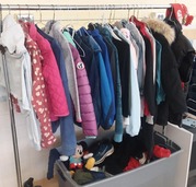 Clothing and other lost items hanging on our Lost and Found rack.