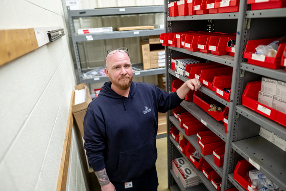 DJ smiling for a photo in the warehouse