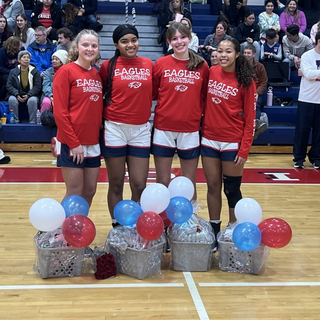 4 girls standing on the basketball court