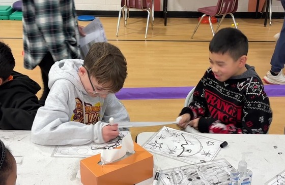 Two students doing an activity that shows fine motor skill challenge