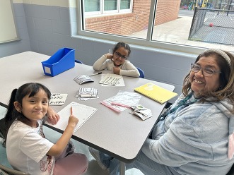 Teacher and students learning at a table