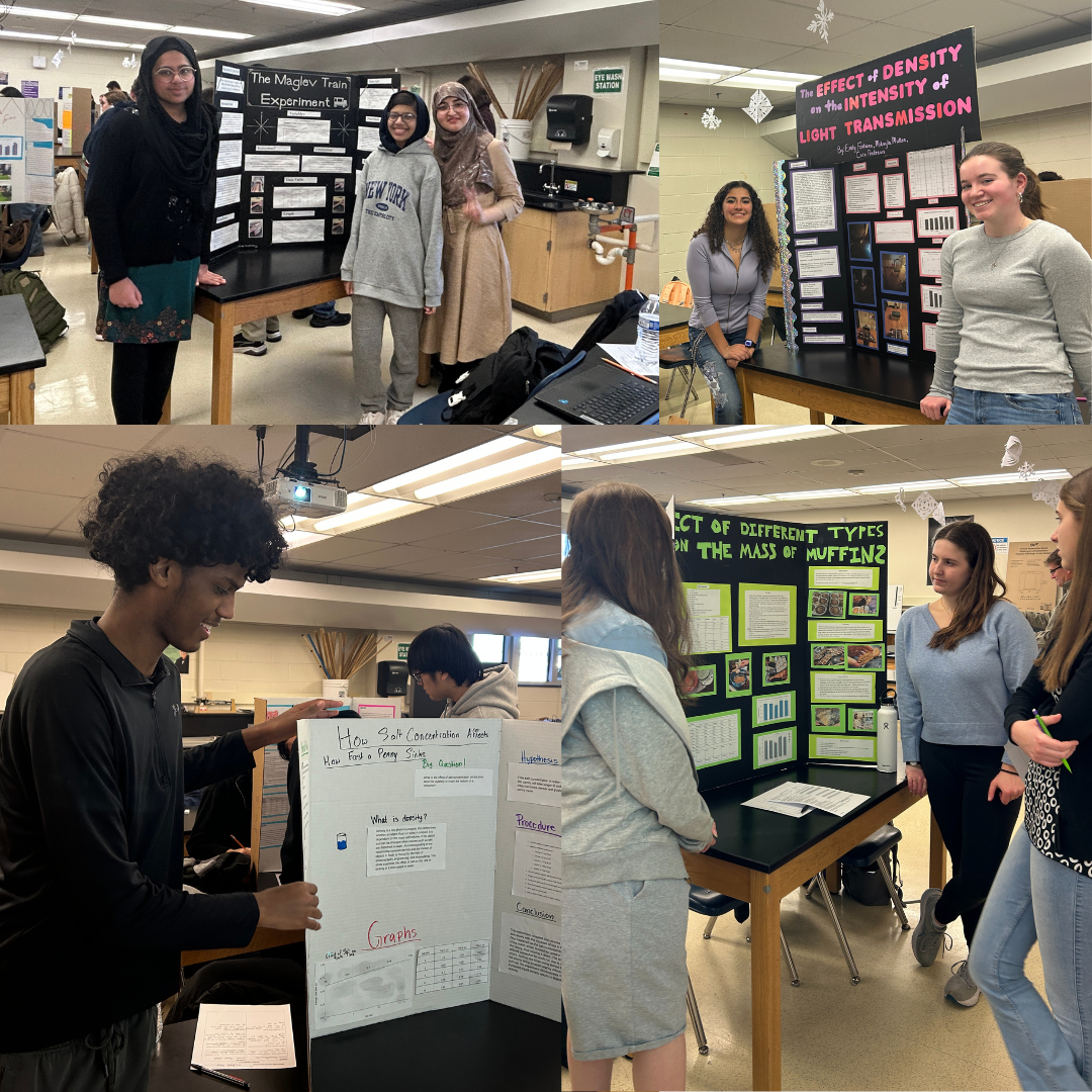 students standing in front of their science fair boards