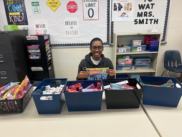 a student sitting behind bins