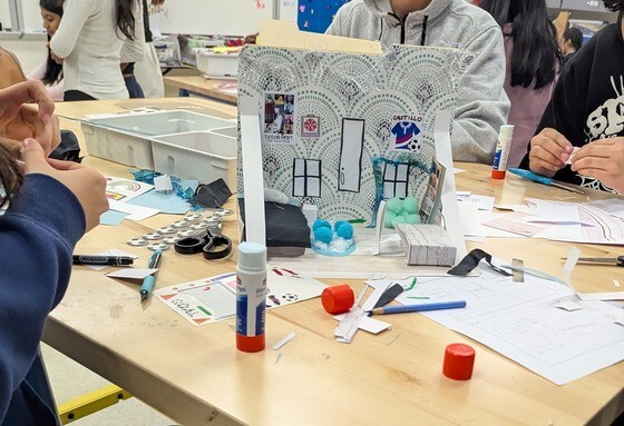 Students creating houses with crafts