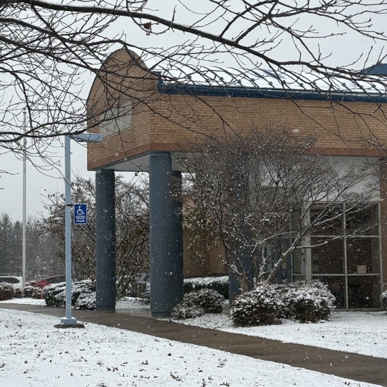 Entrance to Lane Elementary with snow falling