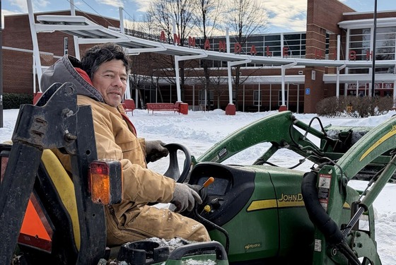 person working on a snow plow