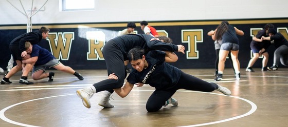 students wrestling on the mat