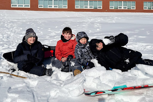 students playing in the snow