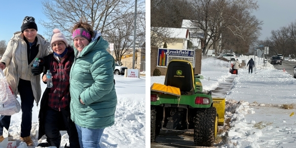 Three staff members, holding a bag of food, outside of Brookfield Elementary, clearing snow from the sidewalk.