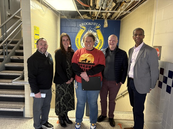 Principal, Leslie Hassen, surrounded by representatives from the FCPS leadership and School Board
