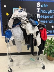 Clothes left outside bundled in a pile on a cart