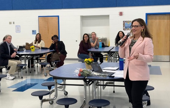 Melanie talking at a community summit