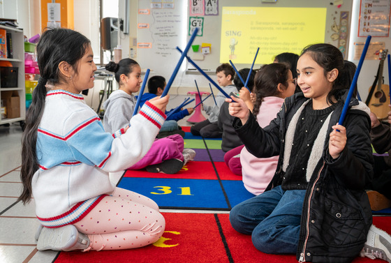 Students using music sticks.