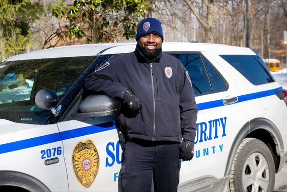 Office of Safety and Security Officer Gregory Sutherlin smiles on his patrol at Dogwood Elementary School.