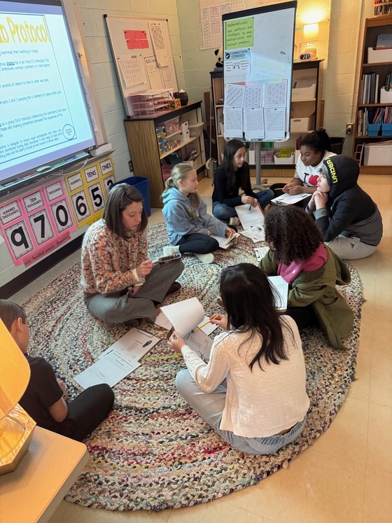 Ms. Walsh working with 5th graders