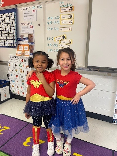 Two little girls in Wonder Woman costumes