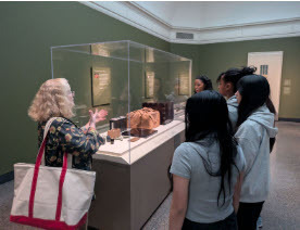 individuals viewing a museum display