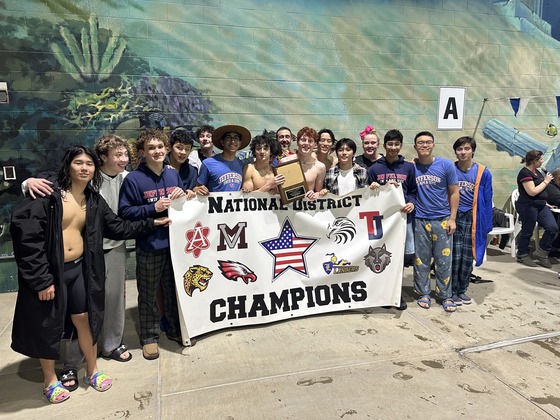 Boys Swim and Dive Team posing with National District Championship banner