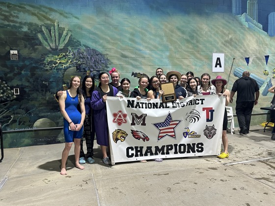 Girls Swim and Dive team poses with National District championship banner.